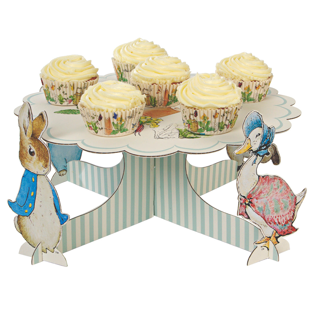 Though Peter Rabbit is now well over 100 years old, Beatrix Potter's charming creation is as beloved as ever, making him and his friends the perfect special guests for any celebration. That's why they feature on this beautiful cupcake stand, featuring Beatrix Potter's classic illustrations, and four stand-up characters. Simply load with cupcakes for the perfect centerpiece for your party!   Assembled size: 360mm x 180mm x 360mm