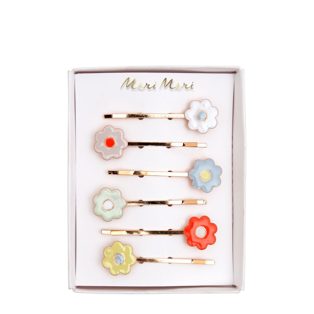 Add an instant touch of floral beauty to any hairstyle with these pretty Daisy Enamel Hair Slides. Crafted from pastel colored enamel with gold tone slides. Perfect as a Springtime gift.   6 colors Product dimensions: 2