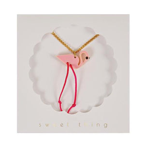 There's nothing quite like the pleasure of opening up a full jewellery box and rummaging through it for the perfect accessory... So whether you're looking for a treat for yourself, or a gift for a little girl (or a grownup one, for that matter), we've got you covered. This funky pendant necklace features a brilliant pink flamingo, embellished with dangling pink string legs on a shiny gold chain.   Pink acrylic pendant Neon cord legs Gold tone chain fastener